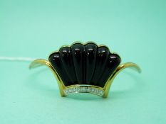 A 14ct gold bangle set with a carved shell shaped piece of onyx and a row of modern round brilliant