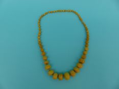 WITHDRAWN An amber necklace of graduated yellow beads,