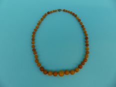 An amber necklace of graduated spherical beads,