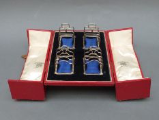 A cased set of four George V hallmarked silver four slice toast racks comprising two pairs,