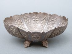 An Eastern white metal quatrefoil embossed dish, width 12cm,