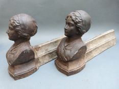 A pair of cast iron figural fire dogs with female busts