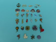 A collection of brooches to include enamel examples,