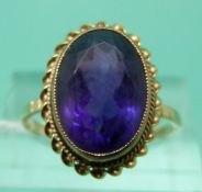 A 9ct gold ring set with an oval cut amethyst (size P)