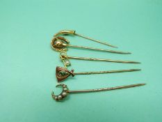 An 18ct gold stick pin set with seed pearls in a crescent,