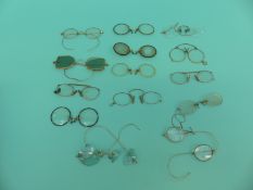 A collection of early spectacles/glasses including tortoiseshell, coloured lenses, gold,
