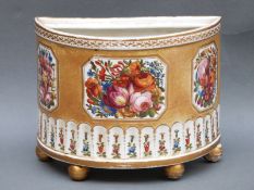 An early 19thC continental porcelain bough pot with floral cartouches on ochre ground,