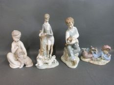Four Lladro figures featuring boys with dogs and lambs