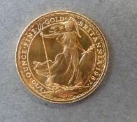A 1987 gold ten pound miniature 1/10 oz Britannia