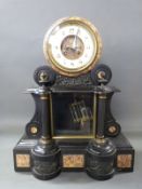 A late 19thC two train slate mantel clock in drum style case,
