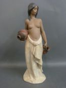 A Lladro figurine of a topless water carrier