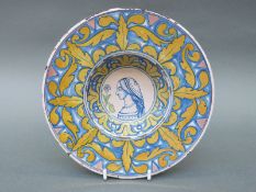 An 18thC portrait plate, possibly Cantagalli, tin glazed with blue and lustre decoration,