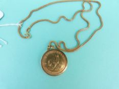 A 1984 half Krugerrand in a yellow metal pendant mount on an 18ct gold chain,