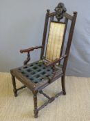 A late 19thC / early 20thC hall or library chair with ornately carved oak frame and upholstered