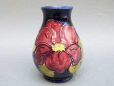 A Moorcroft vase in Clematis pattern on a blue ground,