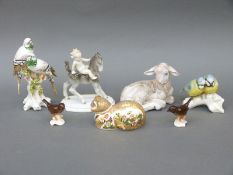 A group of continental porcelain animals and birds including Royal Crown Derby cat paperweight,