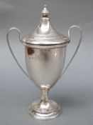 An Edward VII hallmarked silver twin handled covered trophy cup,