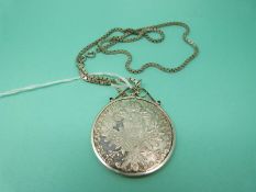 A silver Maria Theresia coin mounted on a square section chain