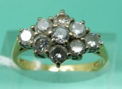 An 18ct gold ring set with round cut diamonds in a cluster,