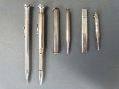 Six hallmarked silver and other propelling pencils, pencil holders including a bridge examples,