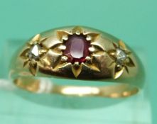 A Victorian ring set with a ruby and two rose cut diamonds in star settings (size R)