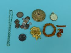 An amber bracelet, amber cufflinks, RAF compact, coins,