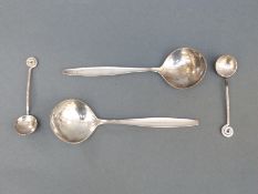 A pair of Georg Jensen white metal spoons marked sterling Denmark, length 14.