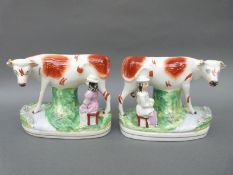 A true pair of 19thC Staffordshire figures of cows with milk maids,