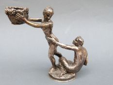 A possibly French white metal figural table salt depicting the devil pursuing a maiden with a