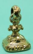 A Victorian gold plated seal / intalgio with a carved agate depicting a lyre