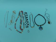 A silver and turquoise necklace, silver pendant in the form of a cat chasing a mouse,