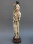 A Chinese early 20thC ivory figure of a lady on wooden base,