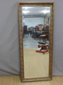 A gilt framed bevelled edge mirror (132 x 57cm)