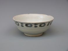 A Chinese blue and white bowl from the Tek Sing cargo wreck in circle and ring pattern,