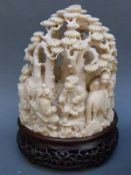 A 19thC Chinese carved ivory figural group depicting figures playing board games and a horse in a