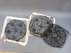 Three early 20thC black sequinned panels, two mounted on paper,