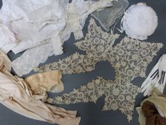 A quantity of early 20thC textiles to include kid mourning gloves,