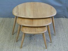 A nest of retro light elm Ercol pebble tables.