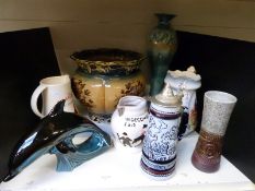A collection of ceramics to include Dickens character jugs by Manor, large Poole dolphin, jugs,