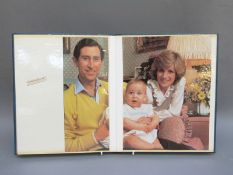 A scrap book containing half an official Christmas card and various colour clippings of the Royal