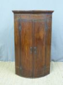 A Georgian inlaid mahogany bow fronted corner cupboard (H105 x W64cm)