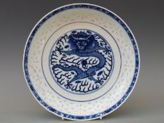 A Chinese pedestal dish with central dragon decoration,
