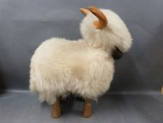 A wood and wool sheep footstool/toy.
