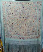 A Chinese Art Deco silk fringed piano shawl with embroidered floral decoration on a green