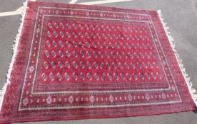 A Persian rug, red generic motif on a red ground,