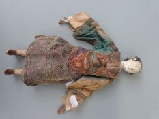A late 19th/20thC Chinese doll with embroidered clothing.