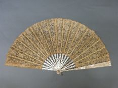 A late 19th/early 20thC mother of pearl and lace fan, the leaf with needle lace floral design,