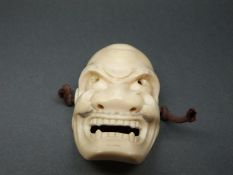 A Japanese Meiji period carved ivory Noh mask, length 5.
