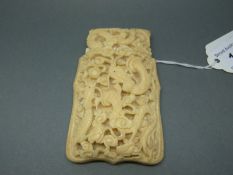 A 19thC deeply carved Chinese card case depicting dragons verso two carved cartouche depicting