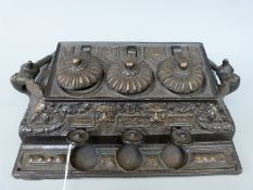 A late 19th/20thC Northern India/Tibetan bronze triple inkwell with push key mechanism to raise the